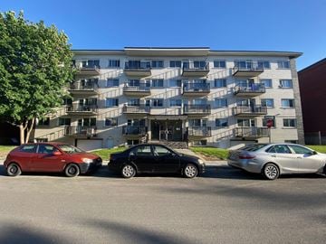 Lachine apartment for rent - three cars parked in front of an apartment building