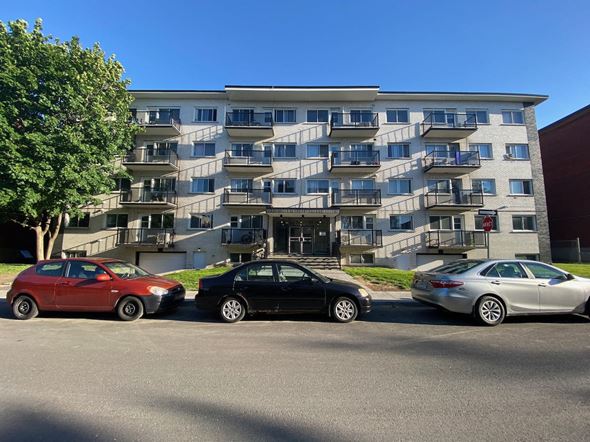 Lachine apartment for rent - three cars parked in front of an apartment building