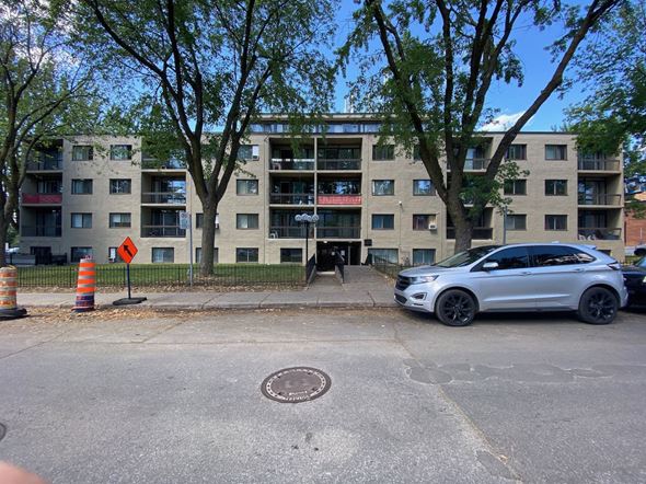 Montreal-Nord apartment for rent - a car parked in front of an apartment building