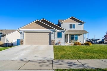 Rathdrum house for rent - a white house with a garage door and a lawn