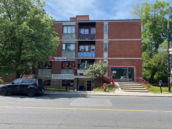 Montreal apartment for rent - a building with a car parked in front of it
