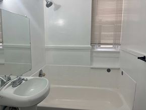 Cleveland apartment for rent - a small bathroom with a sink and a bath tub