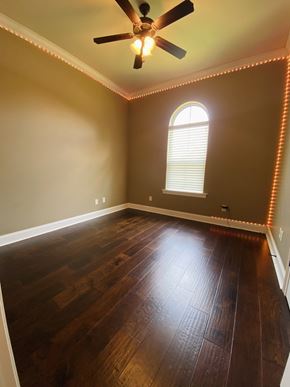 Broussard house for rent - the living room with hardwood floors and a ceiling fan
