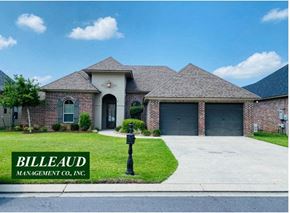 Broussard house for rent - a brick house with two garage doors and a driveway