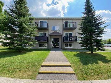 Granby apartment for rent - the front of an apartment building with a sidewalk and trees