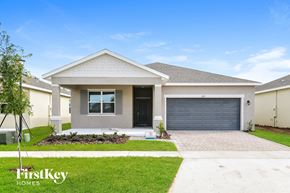 Kissimmee house for rent - a house with a driveway and a garage door