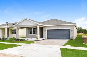 Kissimmee house for rent - a house with a driveway and a garage door