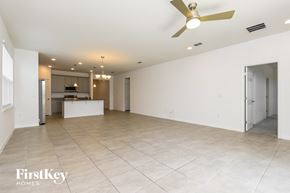 Kissimmee house for rent - A spacious room with a ceiling fan and tiled flooring.