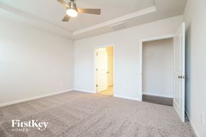 Greenville house for rent - a bedroom with white walls and carpet and a door to a closet
