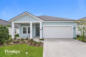 Palm Coast house for rent - a blue house with a driveway and a garage door
