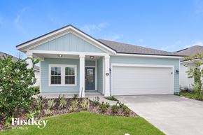 Palm Coast house for rent - a blue house with a driveway and a garage door