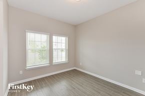 Palm Coast house for rent - the spacious living room with hardwood floors and two windows