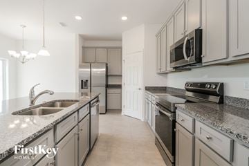 Bartow house for rent - a kitchen with granite counter tops and stainless steel appliances