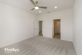 Bartow house for rent - a spacious living room with white walls and a ceiling fan