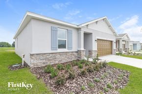 Bartow house for rent - A modern house with a stone border and a well-maintained garden.