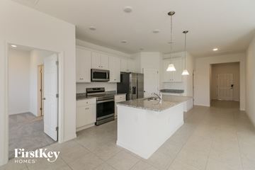 Bartow house for rent - A kitchen with a white island and stainless steel appliances.