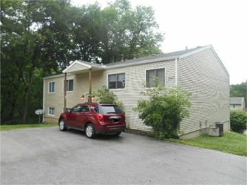 Davenport apartment for rent - a red car parked in front of a white house