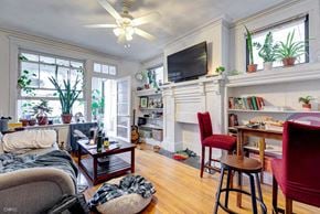 Chicago apartment for rent - A living room with a fireplace and a television.