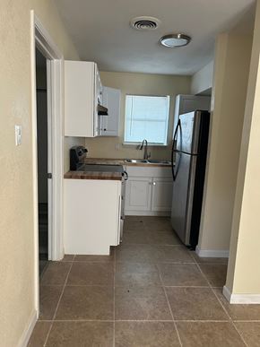Copperas Cove apartment for rent - A kitchen with a refrigerator, sink, and cabinets.