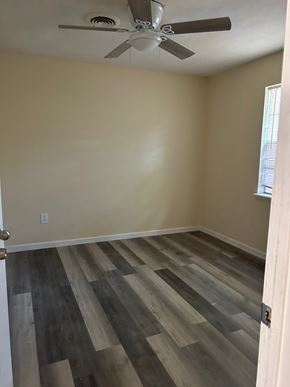 Copperas Cove apartment for rent - A room with a ceiling fan and wooden flooring.