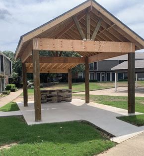 Beebe apartment for rent - A wooden pavilion with a sloped roof and a concrete walkway in front.