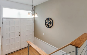 Greenville house for rent - A white door is on the left and a clock is on the wall.