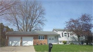 Bettendorf apartment for rent - A house with a white garage door and a brick chimney.