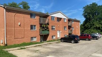 Batavia apartment for rent - A black car is parked in front of a brick building.