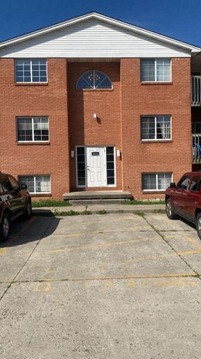 Batavia apartment for rent - A red brick building with a white door and windows.