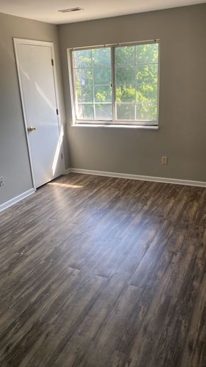 Batavia apartment for rent - A room with a wooden floor and a white door.