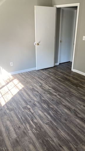 Batavia apartment for rent - A room with a wooden floor and two white doors.