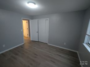Batavia apartment for rent - A room with a wooden floor and white walls.
