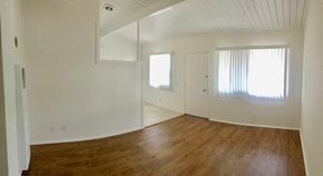 Santa Barbara apartment for rent - an empty living room with white walls and wood floors