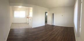 Santa Barbara apartment for rent - A room with wooden floors and white walls.