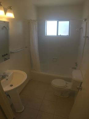 Santa Barbara apartment for rent - A white bathroom with a toilet, sink, and bathtub.