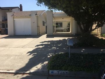 Goleta apartment for rent - A house with a white garage door and a mailbox with the number 7487 on it.