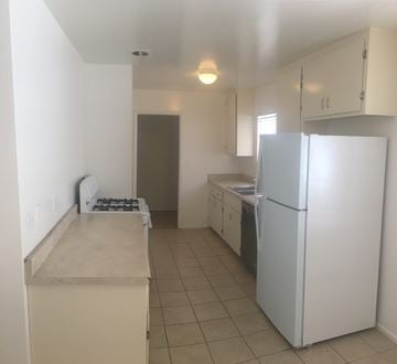 Carpinteria apartment for rent - A kitchen with a white refrigerator and a white counter.