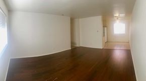 Carpinteria apartment for rent - Empty room with wooden floor and white walls.