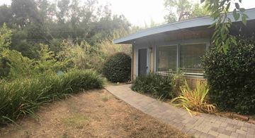 Goleta apartment for rent - A house with a grey roof and a small garden in front.