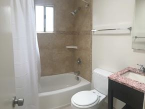 Goleta apartment for rent - A white toilet sits next to a bathtub in a bathroom.