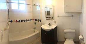 Santa Barbara apartment for rent - A bathroom with a white toilet, a white sink, and a white bathtub.