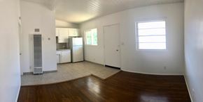 Santa Barbara apartment for rent - A large empty room with a wooden floor and white walls.