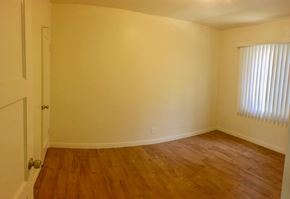 Santa Barbara apartment for rent - A room with wooden floors and a white door.