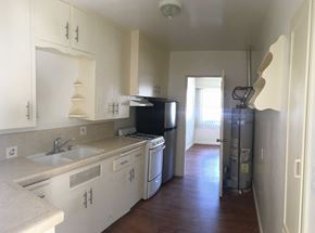 Santa Barbara apartment for rent - A kitchen with white cabinets and appliances.