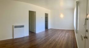 Santa Barbara apartment for rent - A room with wooden floors and white walls.
