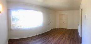 Santa Barbara apartment for rent - A room with wooden floors and white walls.