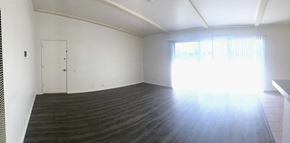 Goleta apartment for rent - A large empty room with wooden floors and a white door.