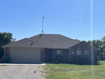 Ponder house for rent - a brick house with a antenna on top of it