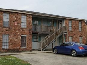 Lafayette apartment for rent - a blue car parked in front of a brick building