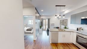 Winnipeg apartment for rent - A modern kitchen with a stainless steel oven and white cabinets.